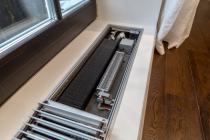 Устройство внутрипольного конвектор Klima c принудительной конвекцией в интерьере
